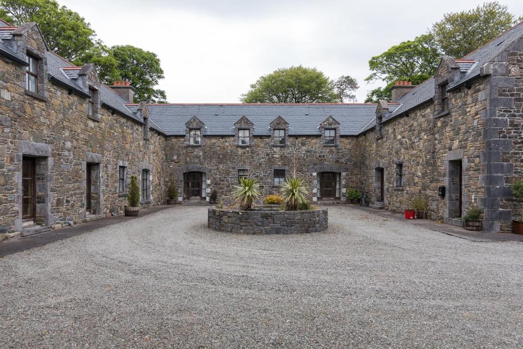 an empty courtyard of an old stone building at Clós Na Feirme in Galway