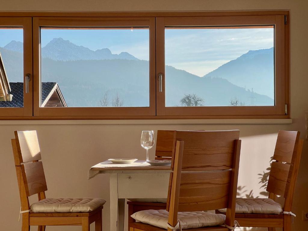 a table and chairs in a room with a window at Apartment Vinomna in Rankweil