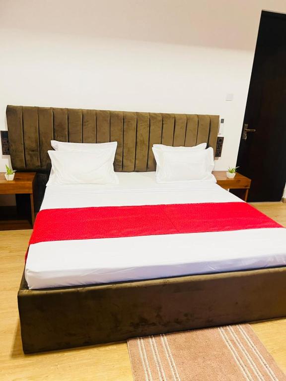 a large bed with a red and white blanket at REEF VIEW Beach Hotel in Matara