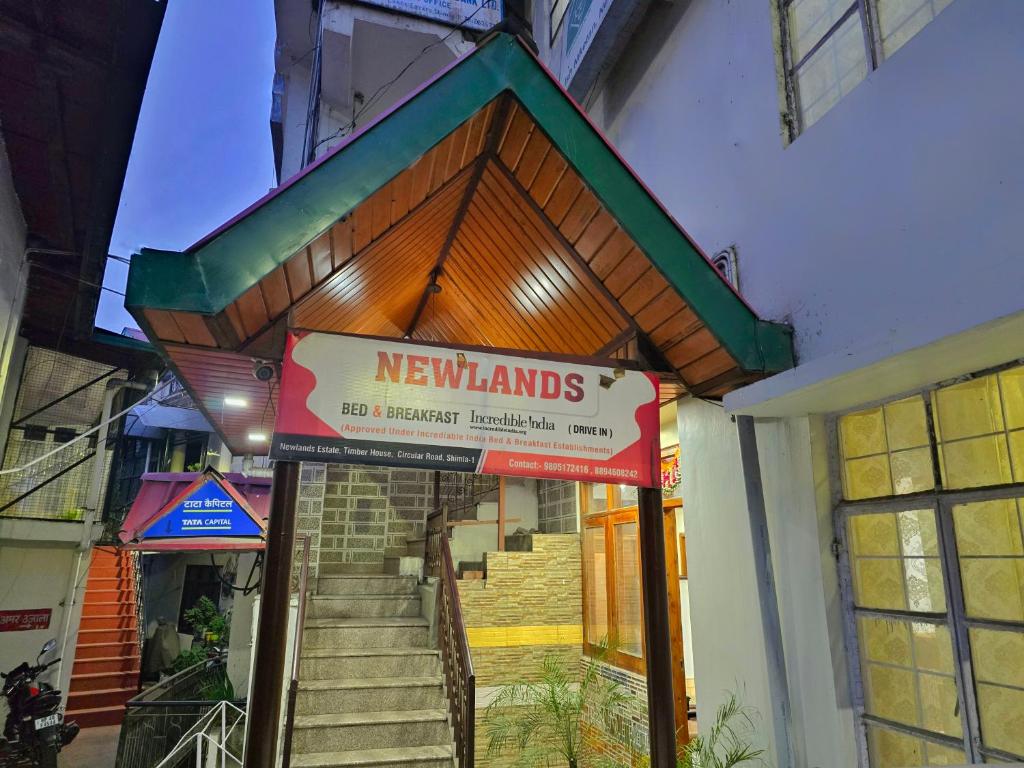 a building with a sign in the front of it at Newlands homestay near mall in Shimla