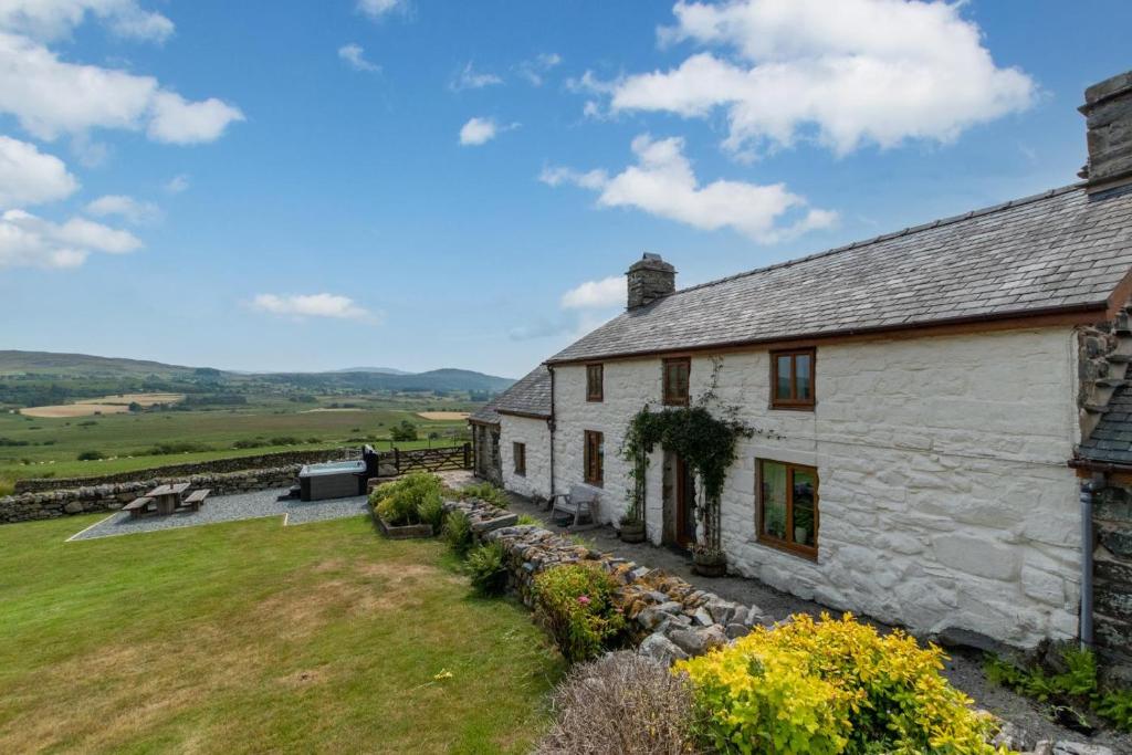 an old stone house with a garden in front of it at 3 Bed in Blaenau Ffestiniog oc-wah538 in Trawsfynydd