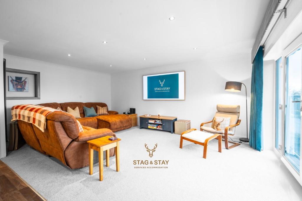 a living room with a couch and two chairs at Stag & Stay- Waterlillie - Contractor friendly, Fast WiFi in Port Glasgow