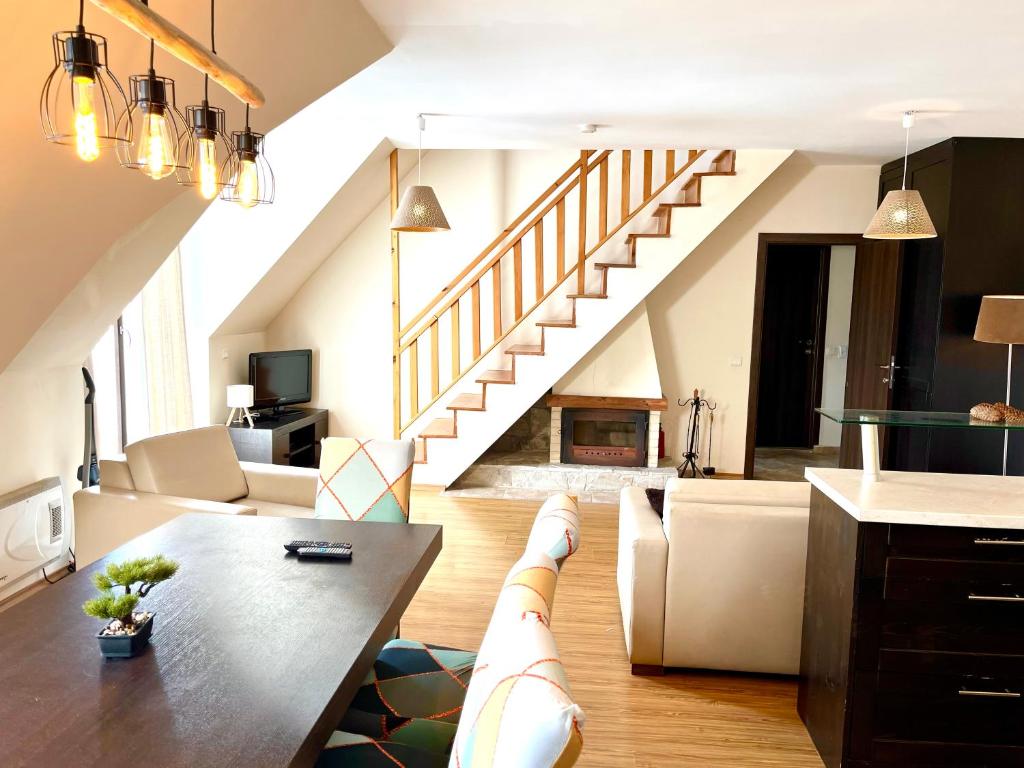 a living room with a couch and a table at Luxury Chalet in Borovets, Rila Views & Fireplace in Borovets