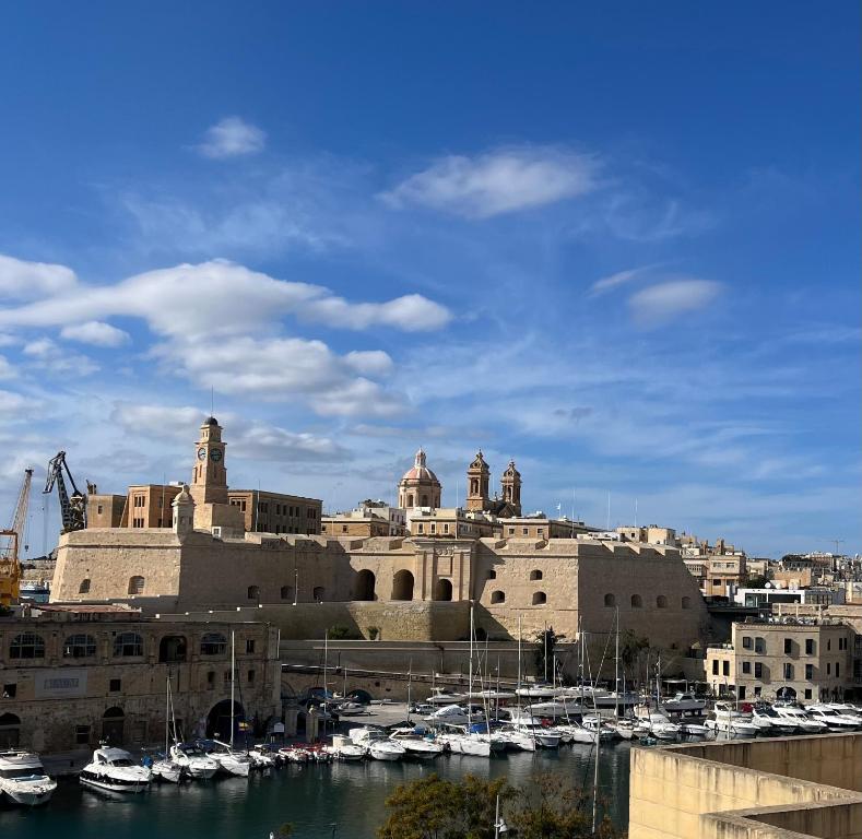 a large building with boats docked in a harbor at Nelsonhaus -Boutique Guesthouse in Cospicua
