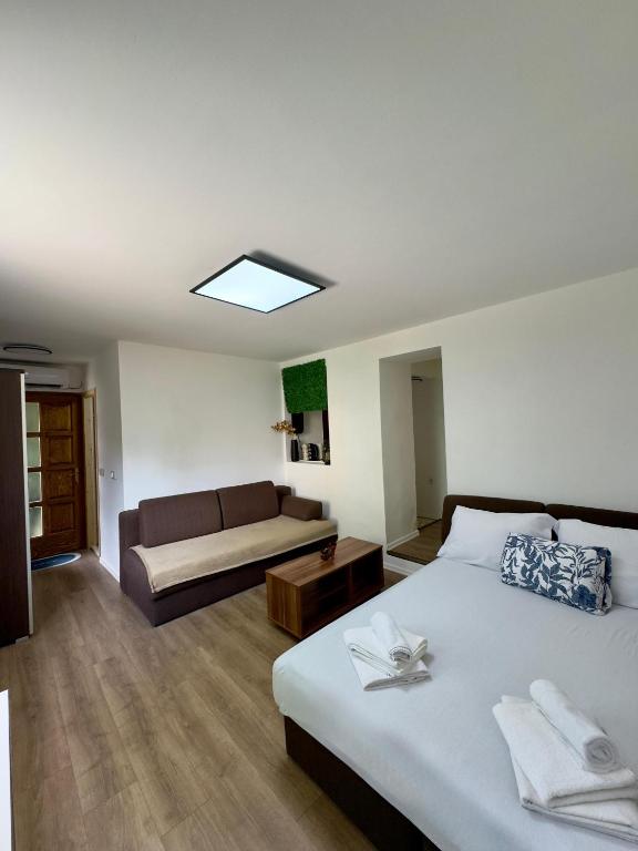 a hotel room with a bed and a couch at Arija Apartment Sarajevo in Sarajevo