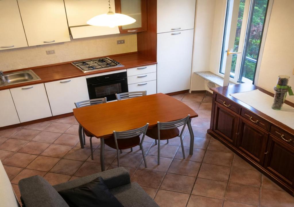 a kitchen with a table and chairs in a kitchen at Milano in Saronno