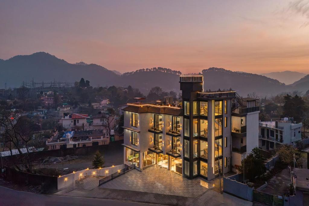 an aerial view of a building with mountains in the background at Perfectstayz Luxe kapilaz - Jacuzzi rooms in Bhowāli