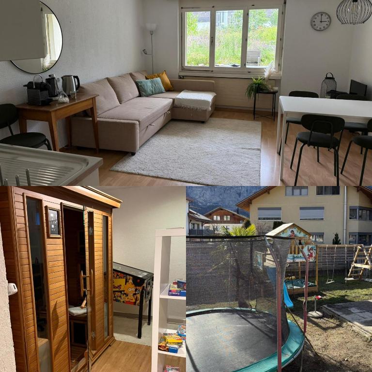 a living room with a couch and a table at Meiringen Retreat - Sauna, Terrace & Pinball in Meiringen