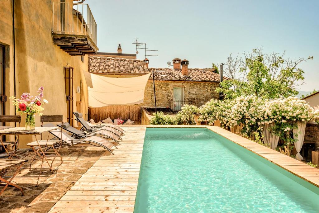 a swimming pool in the backyard of a house at Antica Dimora in Capolona