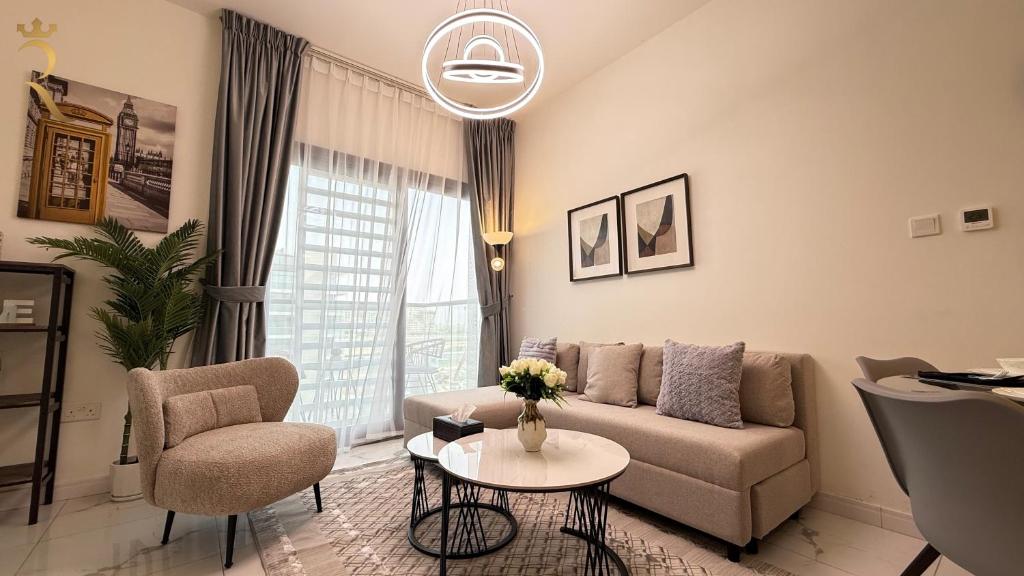 a living room with a couch and a table at Cozy Poolside 1BR - Serene Luxe Chic Retreat in Abu Dhabi