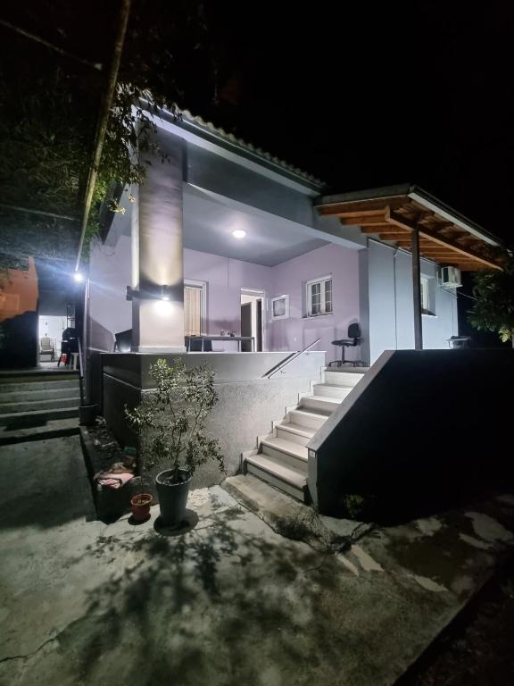 a house with a staircase in the yard at night at La Campagne Ioannina Kranoula in Ioannina