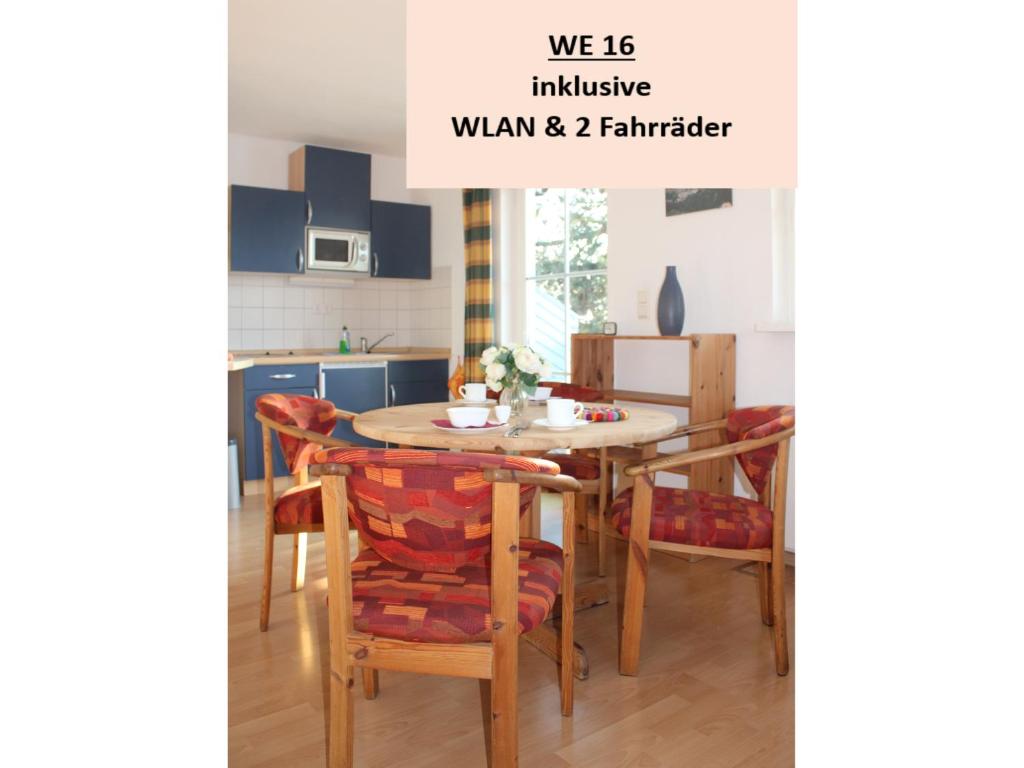 a kitchen with a dining room table and chairs at Koserow_Jugendweg_FeWo 16 in Koserow