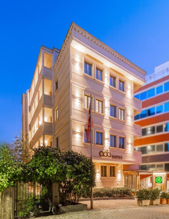 a white building with a flag in front of it at Ada Suites Nisantasi in Istanbul