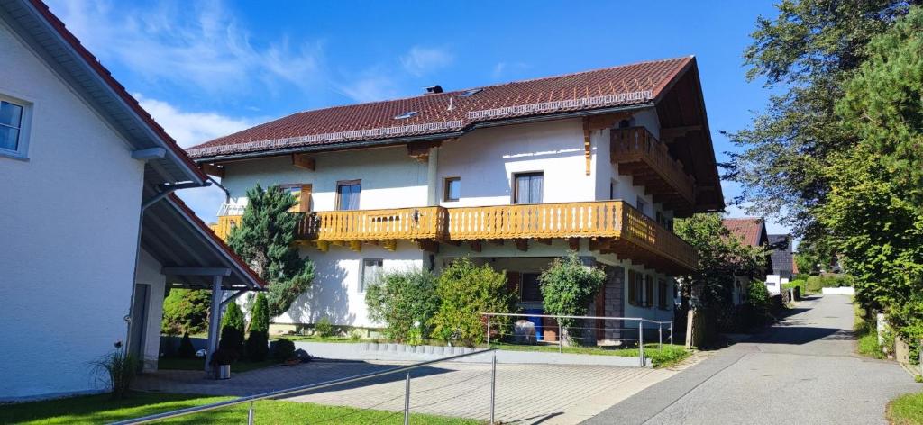 a large house with a balcony on the side of it at Ferienwohnung Liebau in Bayerisch Eisenstein