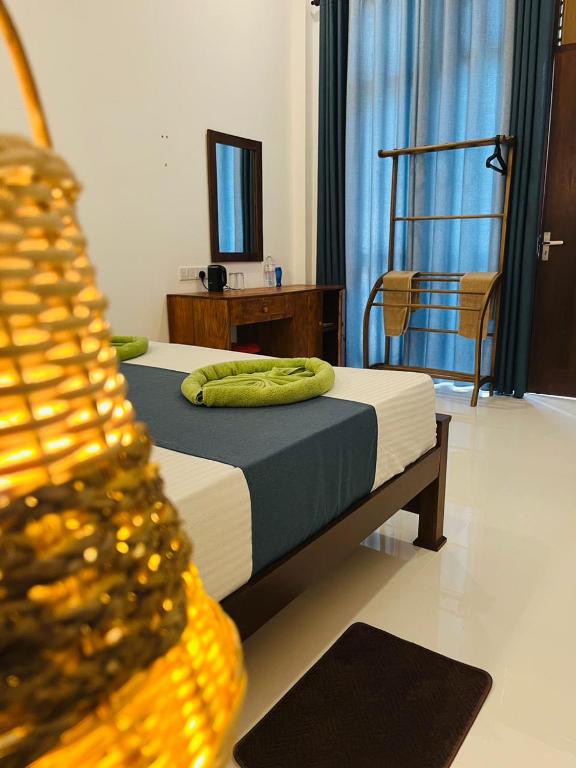 a bedroom with a bed and a chair and a mirror at Luxury Living Villas in Matara
