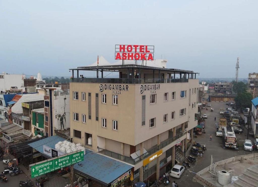 a building with a sign on top of it at ASHOKA hotel in Silvāni