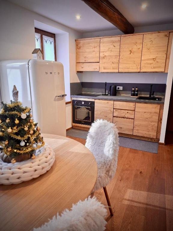 a kitchen with a table with a christmas tree on it at La Casa di Lumi in Lanzada