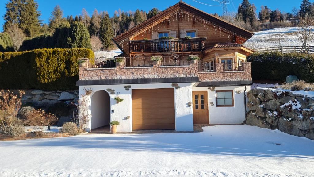 a house with a garage in the snow at Ferienhaus Kleinlercher in Iselsberg