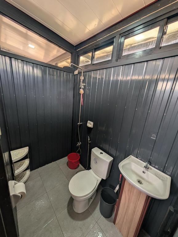 a bathroom with a toilet and a sink at The G Residence in Calatagan