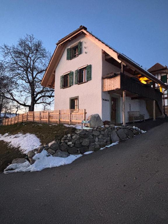 a house on a hill with snow in front of it at Stöckli Gantrisch-Blick in Rüeggisberg