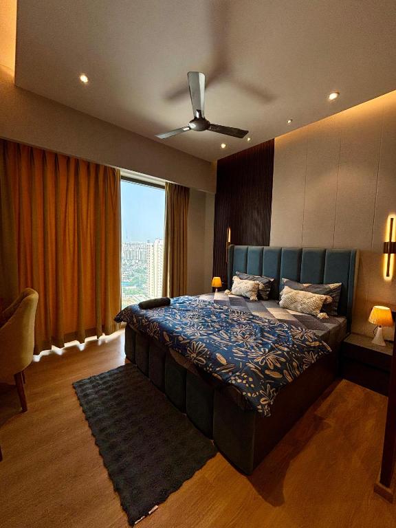 a bedroom with a large bed and a large window at Sky High Nest Noida in Ghaziabad
