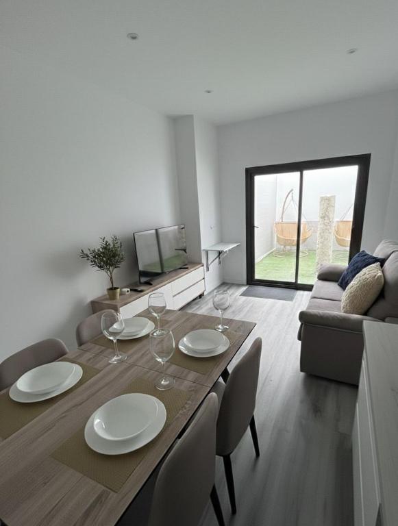 a dining room and living room with a table and chairs at Apartamentos San Gabriel in Alcalá de Henares