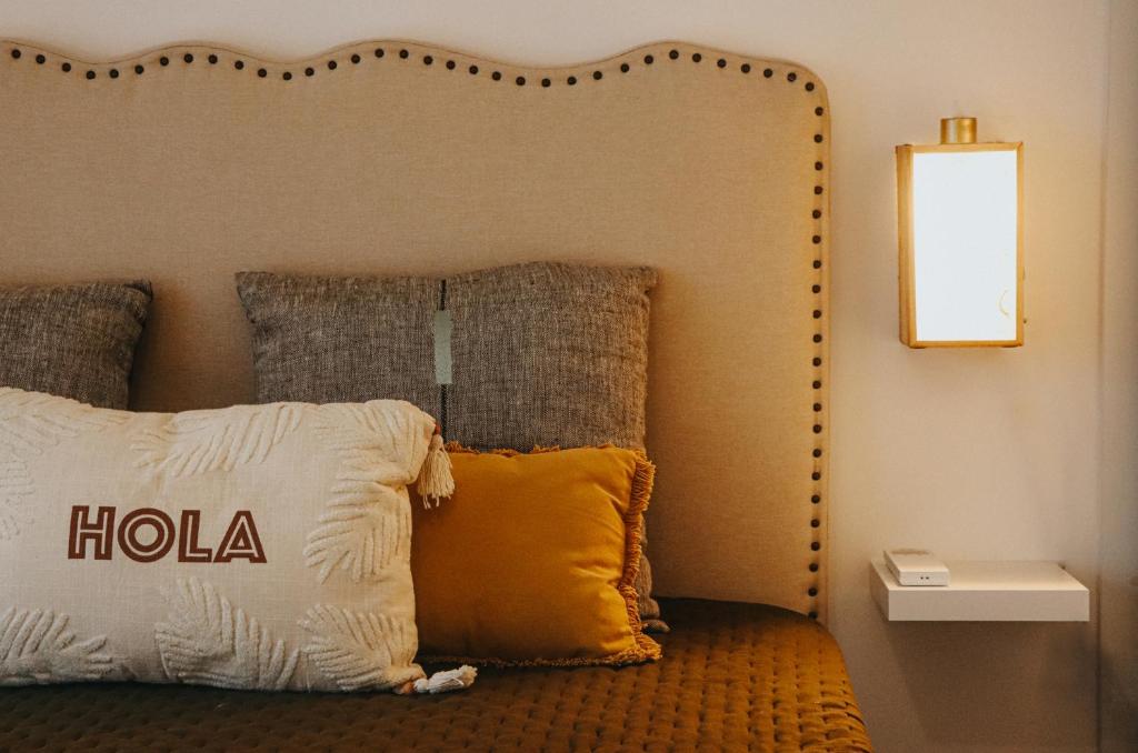 a bed with a large headboard with a pillow on it at Peace In Azores 02 in Ribeira Grande