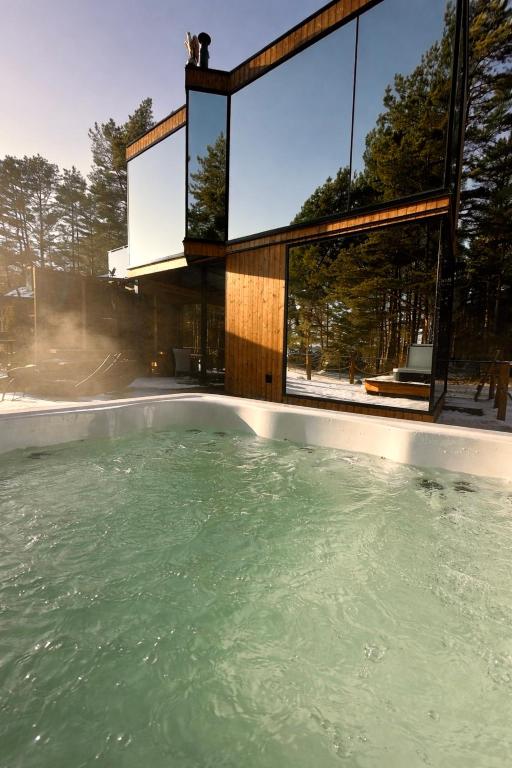 a swimming pool in front of a house at Kihnuvillas - Männirahu in Linaküla
