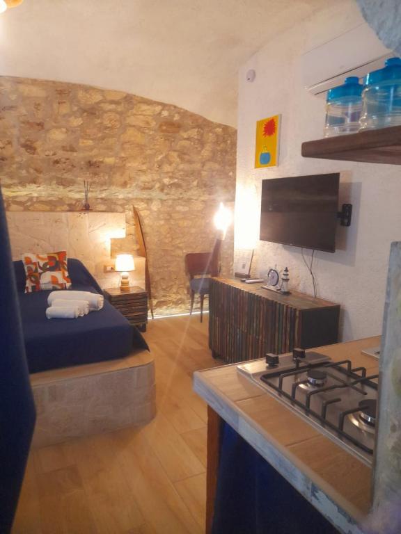a room with a bed and a kitchen with a stove at Mare' in Vieste