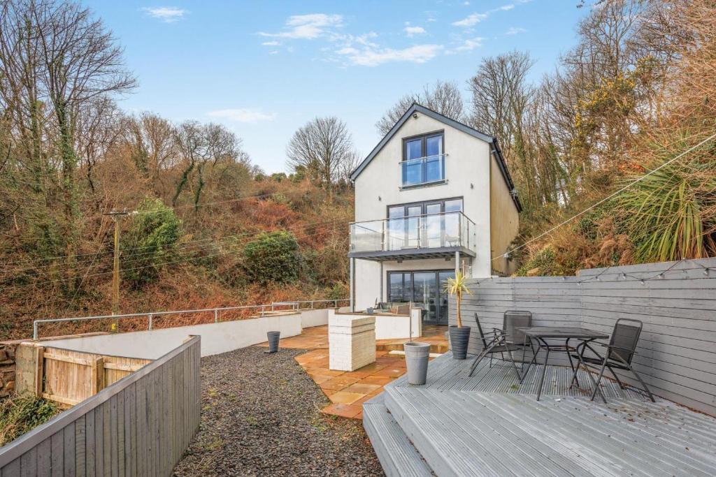 a house with a deck and a table and chairs at 4 Bed in Goodwick oc-s34887 in Goodwick