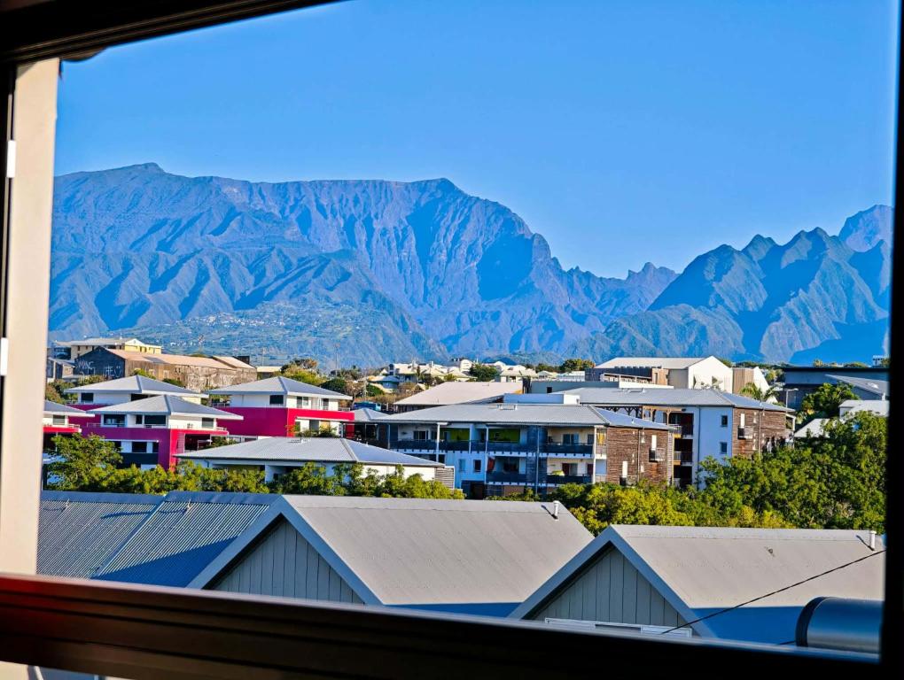 a view of a city with mountains in the background at La Kaz Sumac in Saint-Pierre