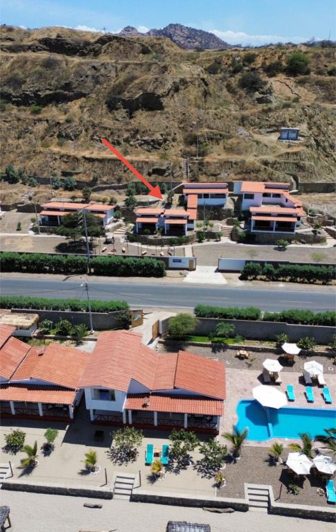 an aerial view of a resort with a mountain in the background at Casuarinas Del Mar Chalet de 2 habitaciones in Canoas de Punta Sal