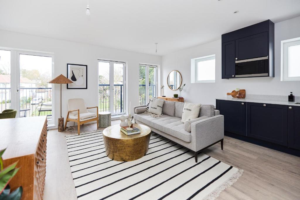 a living room with a couch and a table at 2-Bed Apartments a Short Walk to Wembley Stadium in London