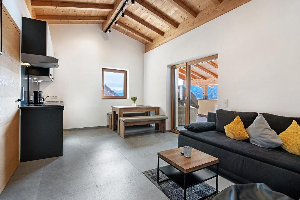 a living room with a couch and a table at Hof Am Egg in Malles Venosta