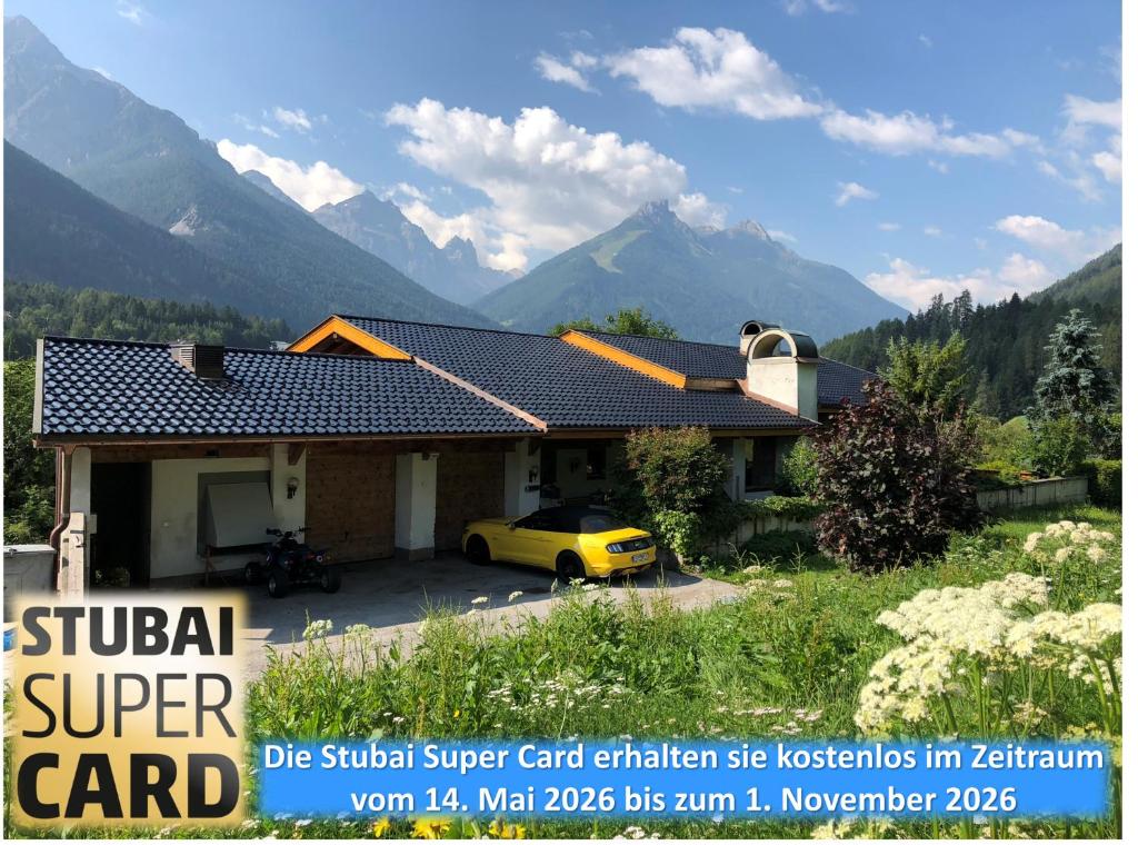 a yellow car parked in front of a house at Apartment Villa Sonnegg in Fulpmes