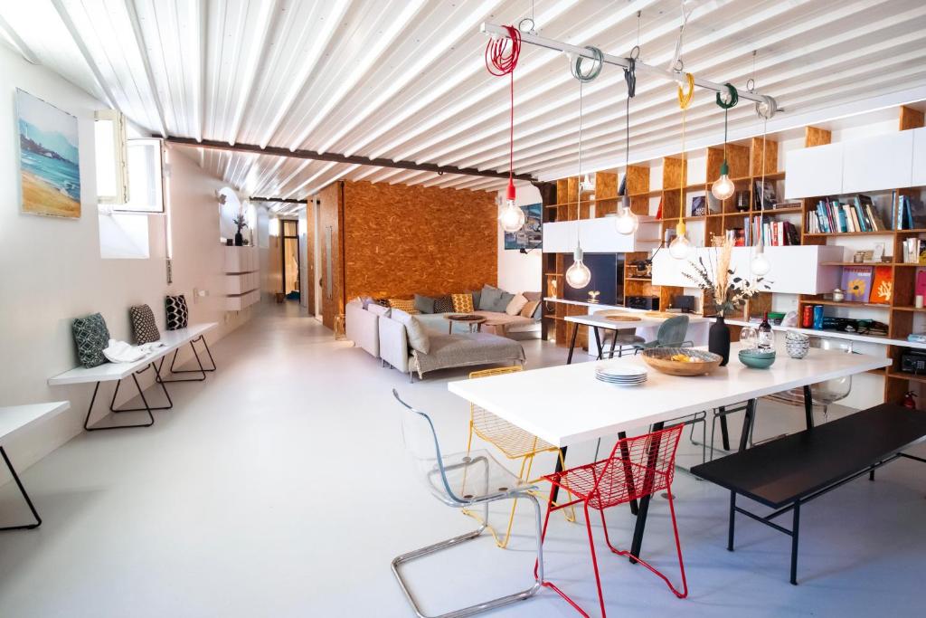 a kitchen and living room with a table and chairs at Surf Sea and Sun in Biarritz