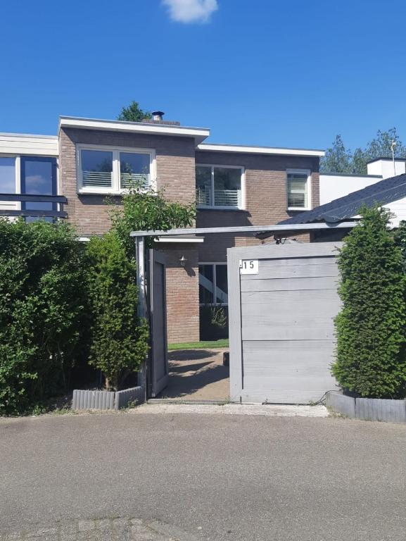 a garage in front of a brick house at Thuis op Flakkee in Ooltgensplaat