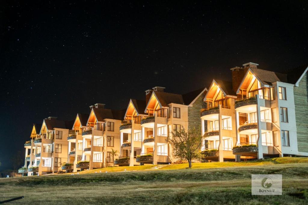 a row of large apartment buildings at night at Boynuz Hotels in Nyahururu
