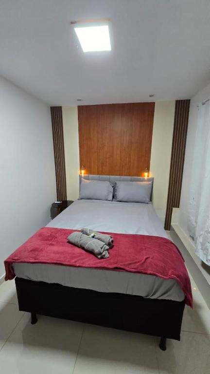 a bedroom with a large bed with a red blanket at Loftt concept in Rio de Janeiro