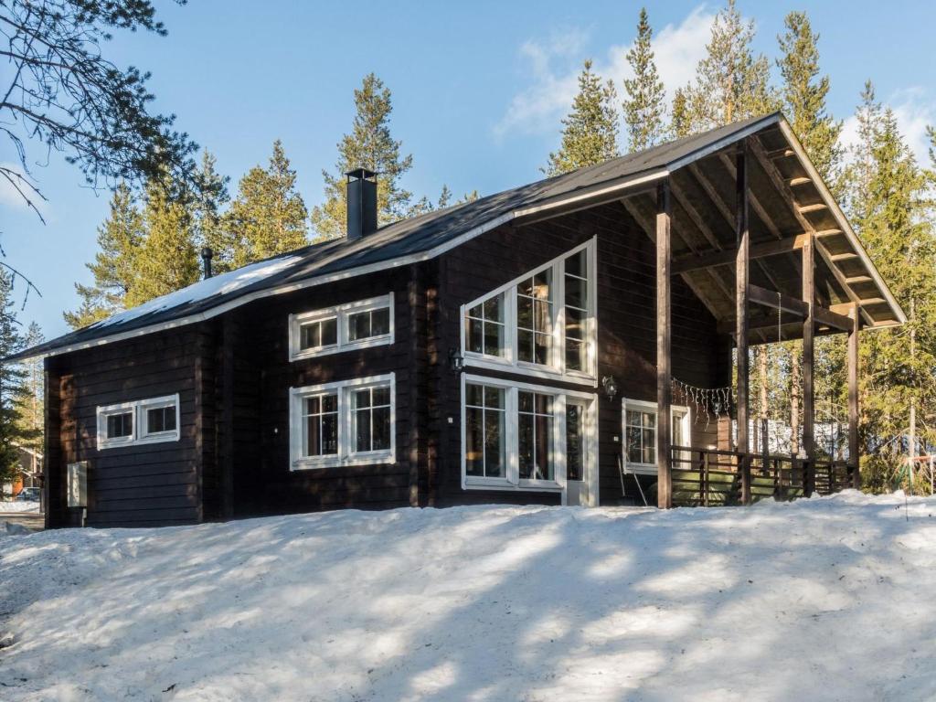 a log cabin in the snow with trees at Holiday Home Levijoutsen by Interhome in Levi