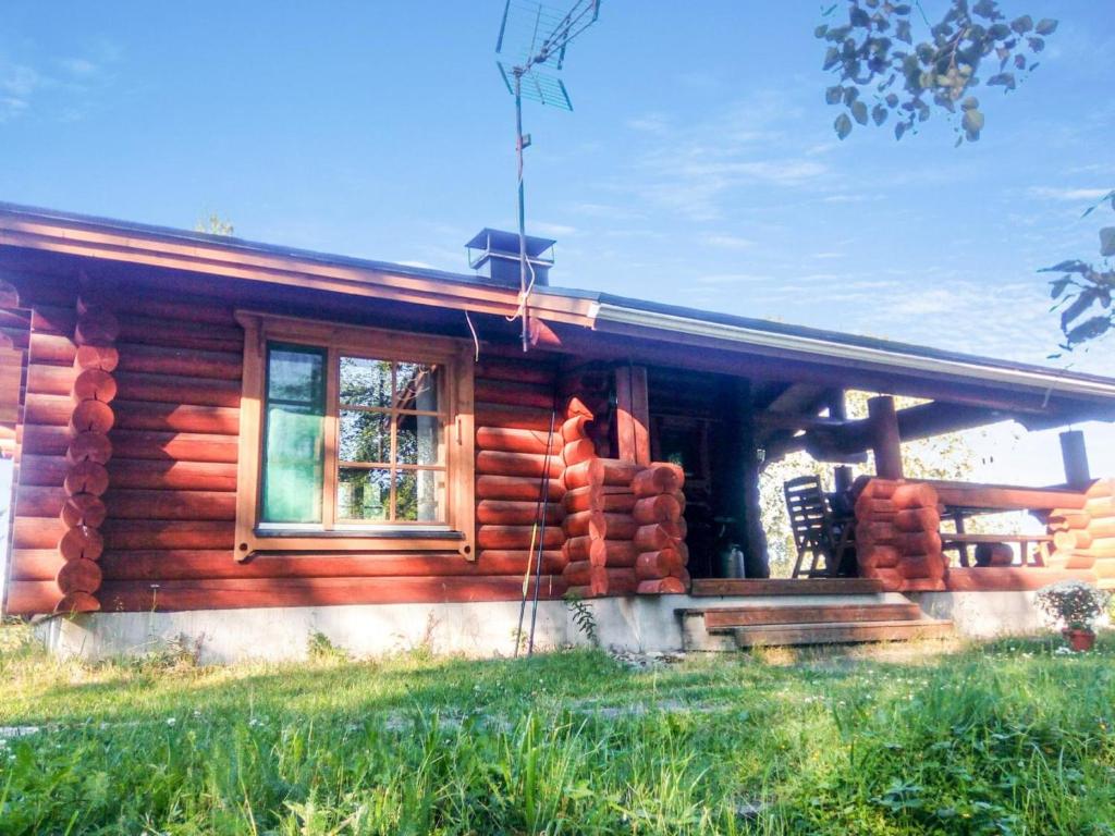 a log cabin with a window on the side of it at Holiday Home Sillankorva by Interhome in Korpijärvi