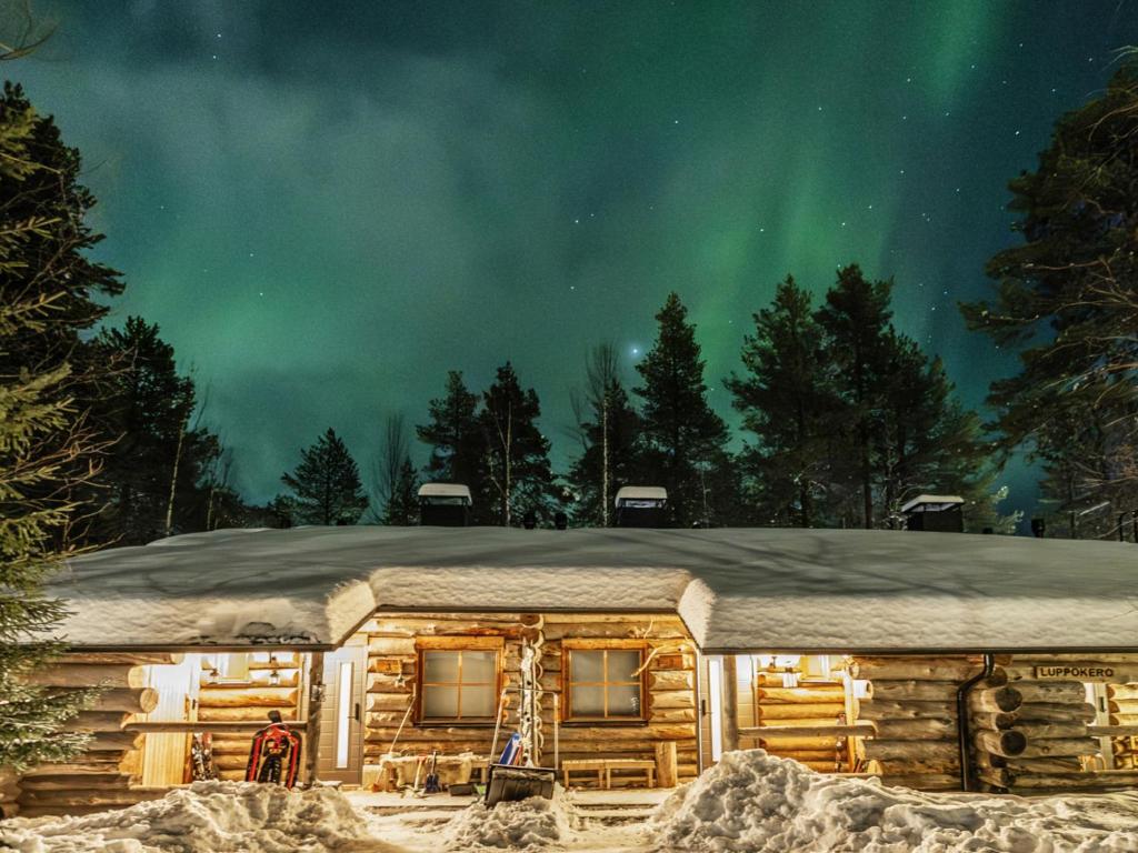 a cabin in the snow under the northern lights at Holiday Home Luppokero 2 by Interhome in Pyhätunturi