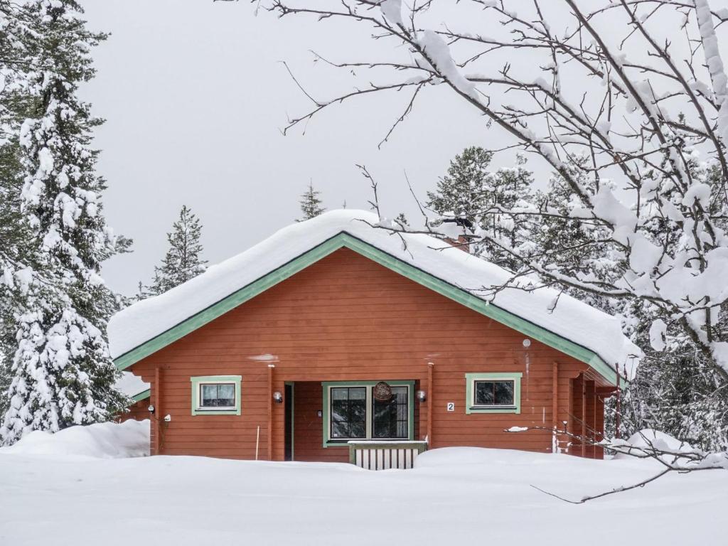 a small red house with snow on the roof at Holiday Home Lomamaja 2 by Interhome in Raattama
