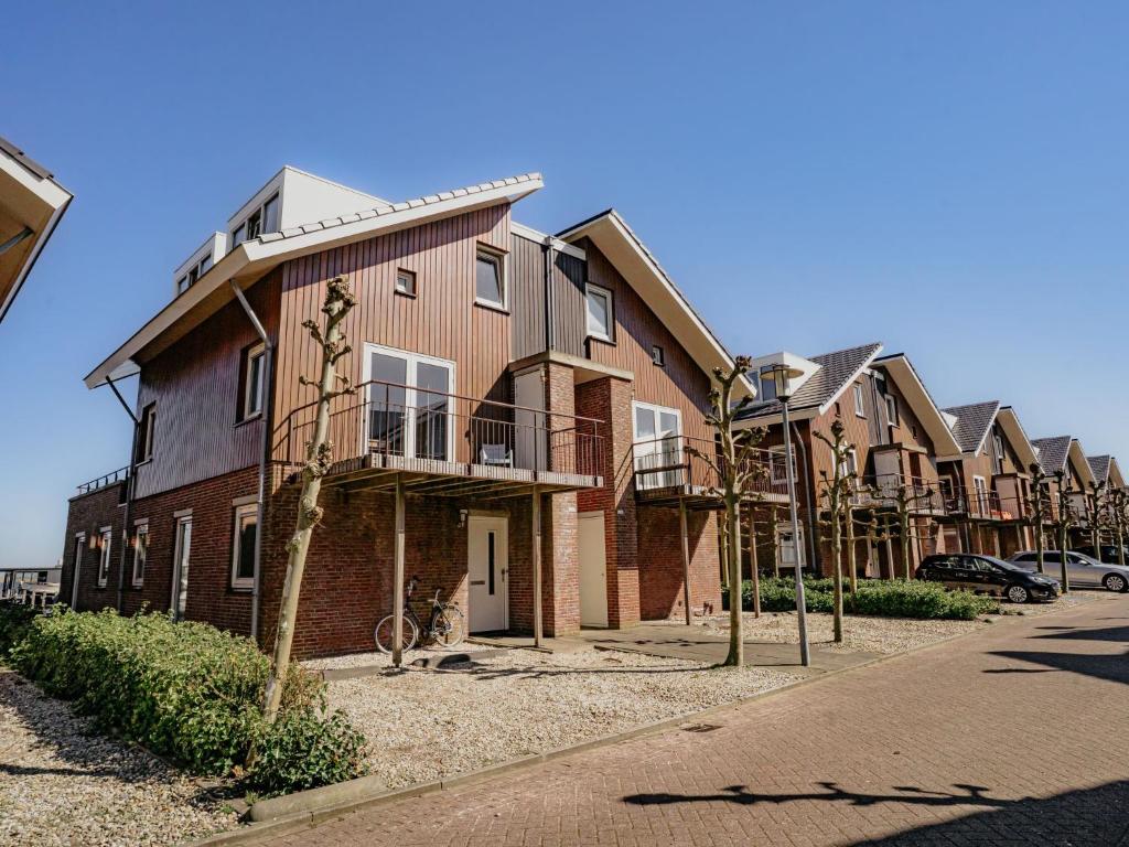 a row of houses on the side of a street at Apartment Oostergeest 2 by Interhome in Uitgeest