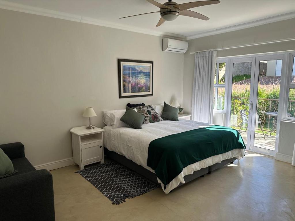 a bedroom with a bed and a ceiling fan at Kasteelberg View in Riebeek-Wes