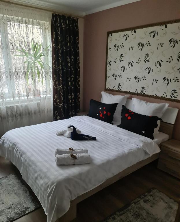 a bedroom with a bed with a cross on it at Casa & Julieta in Tecuci