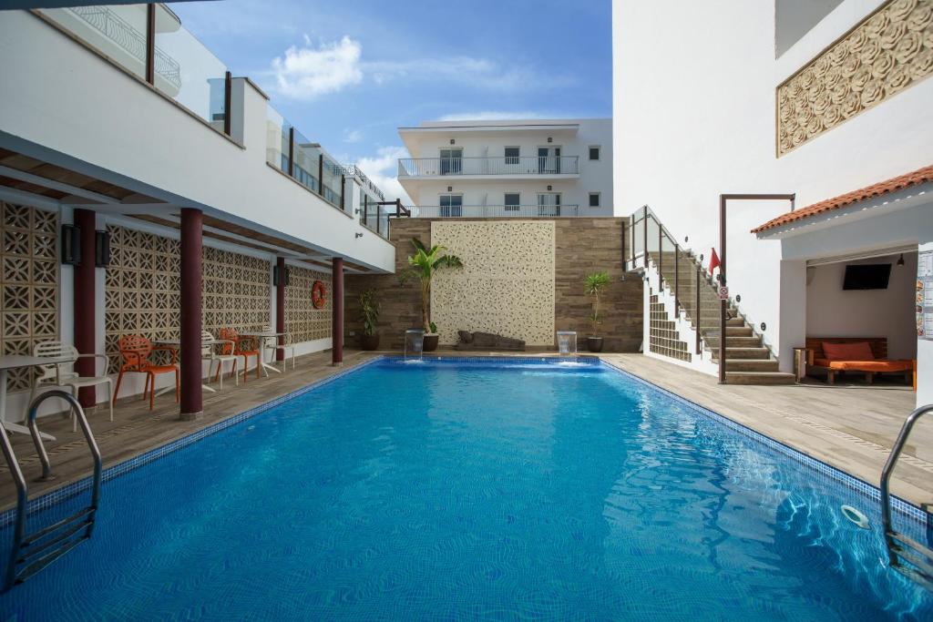 a swimming pool in the middle of a building at Hotel Florencio Ibiza in San Antonio