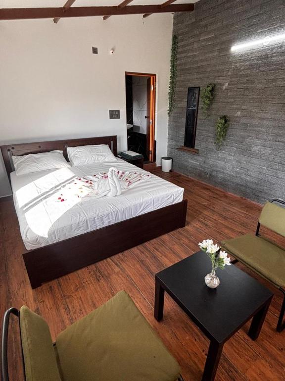 a bedroom with a large bed and a table at Nature's Resort in Kaivār