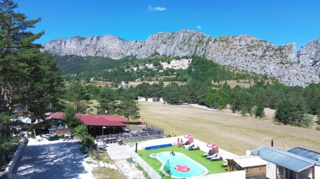 an aerial view of a resort with mountains in the background at ZEcamping 2 avec piscine restaurant vue sur le village de Saint Auban in Briançonnet