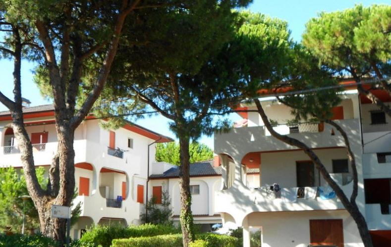 a large white building with trees in front of it at Residence Sporting in Rosolina Mare